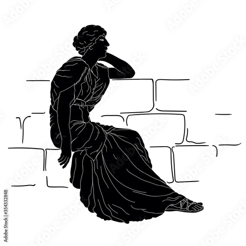 A young Greek woman in a tunic sits on a stone parapet and looks away.