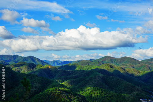 Landscape of the green mountains near Kyoto with sun and beautiful clouds, Japan