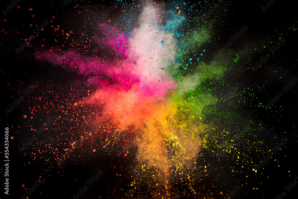 Launched colorful powder on black background, freeze motion