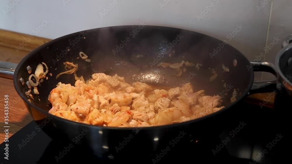 Close-up of cooking a turkey with shrimps and vegetables in wok pan. Close-up of cooking a turkey with shrimps and vegetables in wok pan.