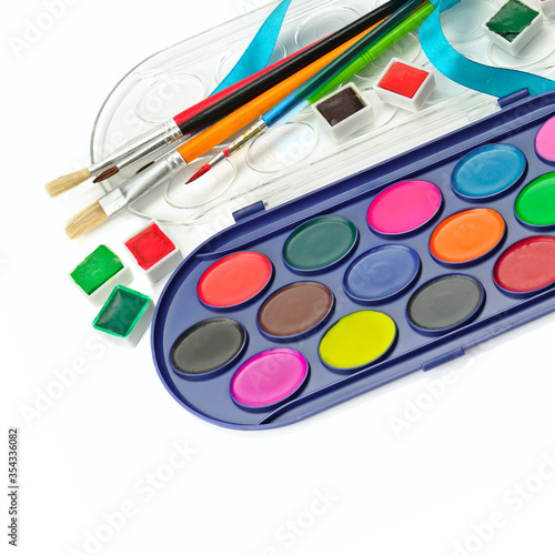 Watercolor paints and brushes for drawing isolated on white background.