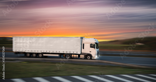 Truck with container on highway, cargo transportation concept. Shaving effect.