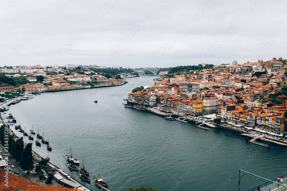 view from the bridge of the old town Porto river and houses with red tiled roofs