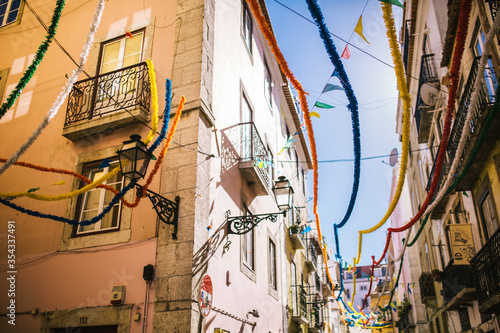 Fototapeta Naklejka Na Ścianę i Meble -  old houses decorated with colored holiday ribbons for the carnival