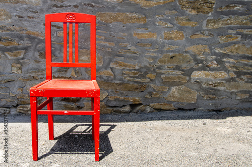 Wooden red chair in the sun