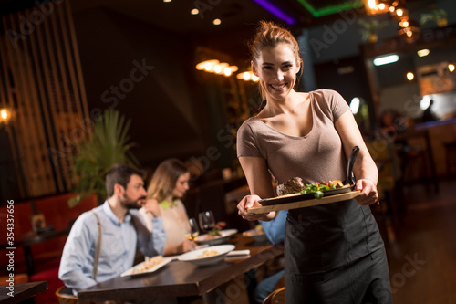 Waiter woman serving group ...