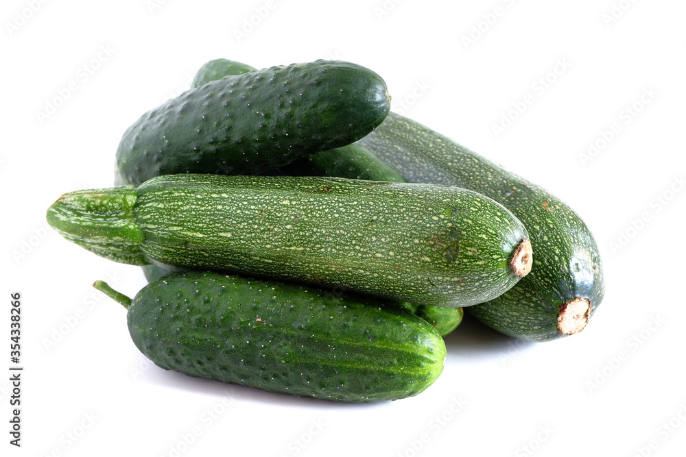 Cucumbers and zucchini on a white background. Suitable for mockups and backgrounds. Food preparation. Vegetables. Cucumbers and zucchini on a white background. Suitable for mockups and backgrounds. Food preparation. Vegetables.