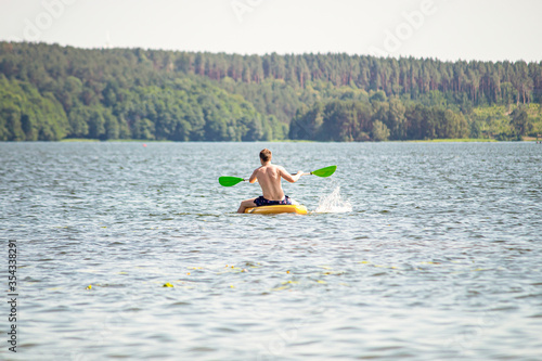 One man rowing a canoe on a lake