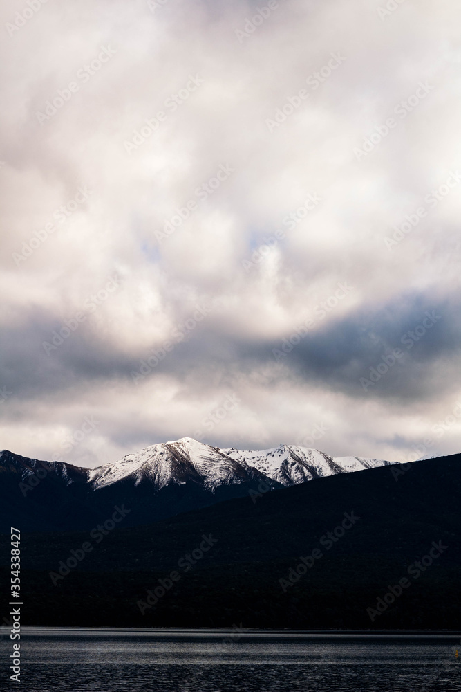 photo of a overcast sky and a mountain range of peaks