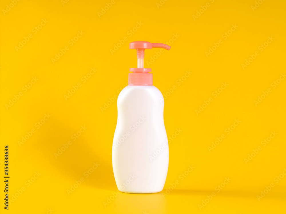 Blank label bottle of antibacterial liquid soap and hand sanitizer mockup on yellow background. White unbranded dispenser bottle isolated on yellow background. Hygiene product and health care. Blank label bottle of antibacterial liquid soap and hand sanitizer mockup on yellow background. White unbranded dispenser bottle isolated on yellow background. Hygiene product and health care.