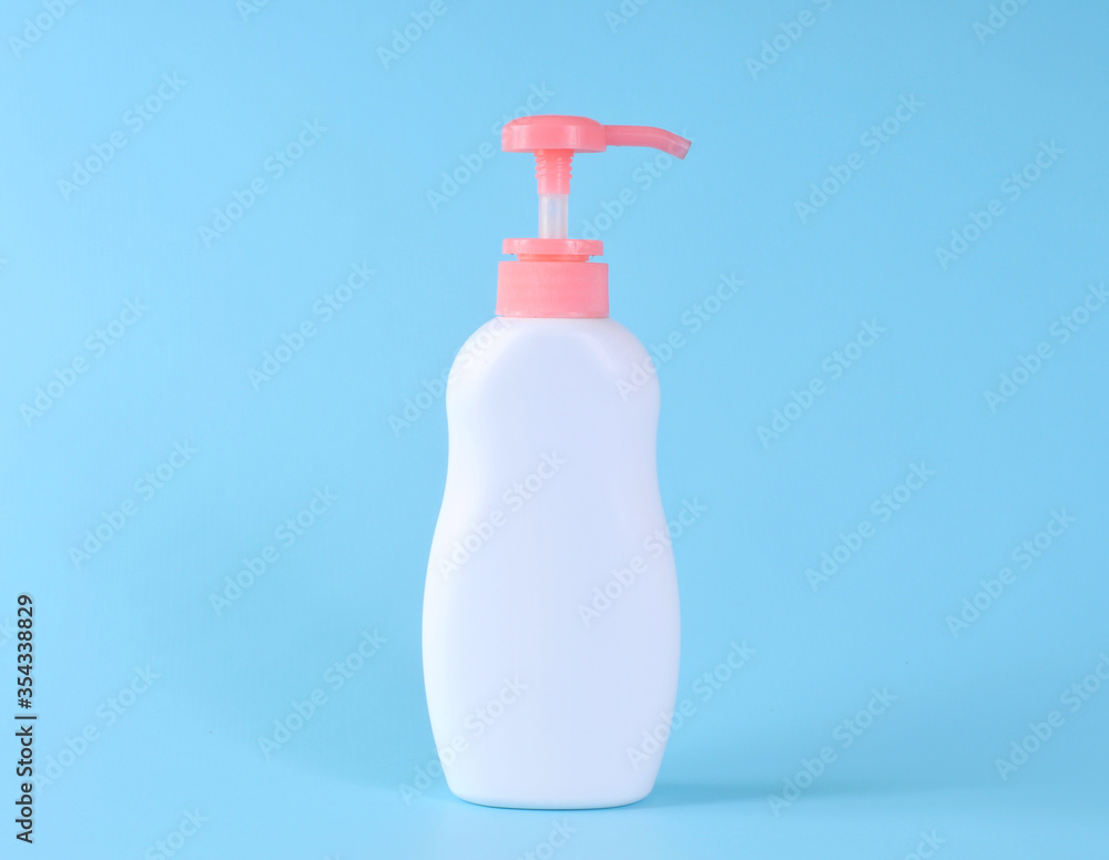 Blank label bottle of antibacterial liquid soap and hand sanitizer mockup on blue background. White unbranded dispenser bottle isolated on blue background. Hygiene product and health care. Blank label bottle of antibacterial liquid soap and hand sanitizer mockup on blue background. White unbranded dispenser bottle isolated on blue background. Hygiene product and health care.