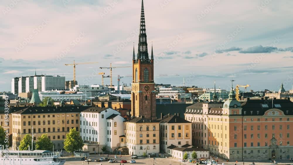 Stockholm, Sweden. Gamla Stan Is Famous Popular Place And Destination Scenic. Riddarholm Church In Sunny Summer Cityscape Skyline. Scenic View Of Embankment In Old Town. UNESCO World Heritage Site. Stockholm, Sweden. Gamla Stan Is Famous Popular Place And Destination Scenic. Riddarholm Church In Sunny Summer Cityscape Skyline. Scenic View Of Embankment In Old Town. UNESCO World Heritage Site.