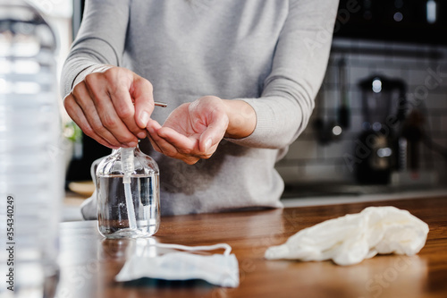 Closeup of woman hands using hand sanitizer liquid for bacteria and virus neutralization. Keep your hands germ-free and virus free with the use of hand sanitizer. Personal Protective Equipment for Inf