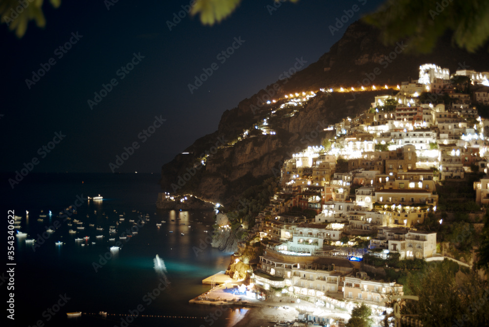 Positano, Italy - August 13, 2018. Night view of the bay in the Mediterranean Sea with yachts from the city.