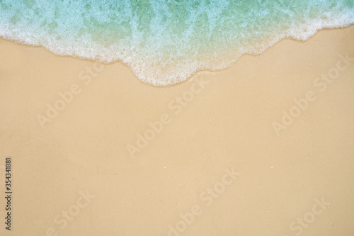 Soft ocean wave on sandy beach.
