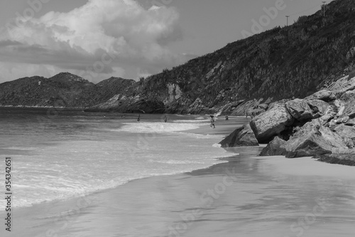 Grayscale shot of a sandy beach on a cloudy sky background in Rio de Janeiro, Brazil photo