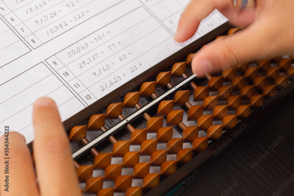 Practicing abacus(Japanese traditional calculator which strengthen mind calculation skill) Practicing abacus(Japanese traditional calculator which strengthen mind calculation skill)
