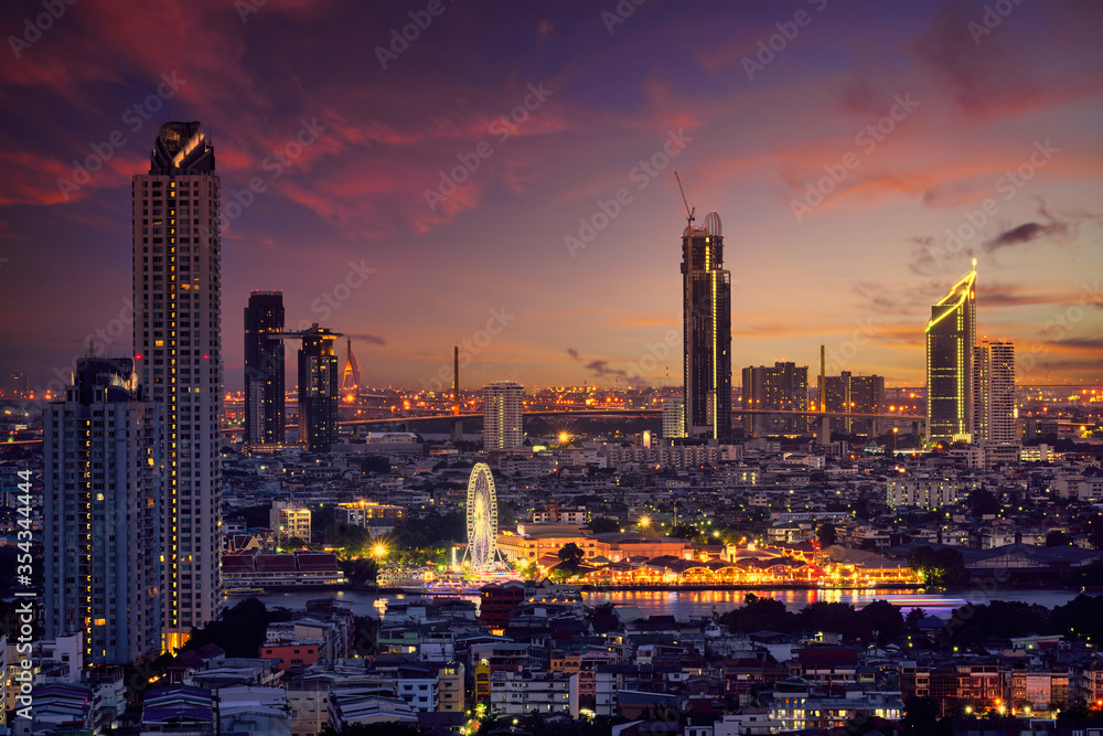 sunset skyline with cityscape  and swing in thailand