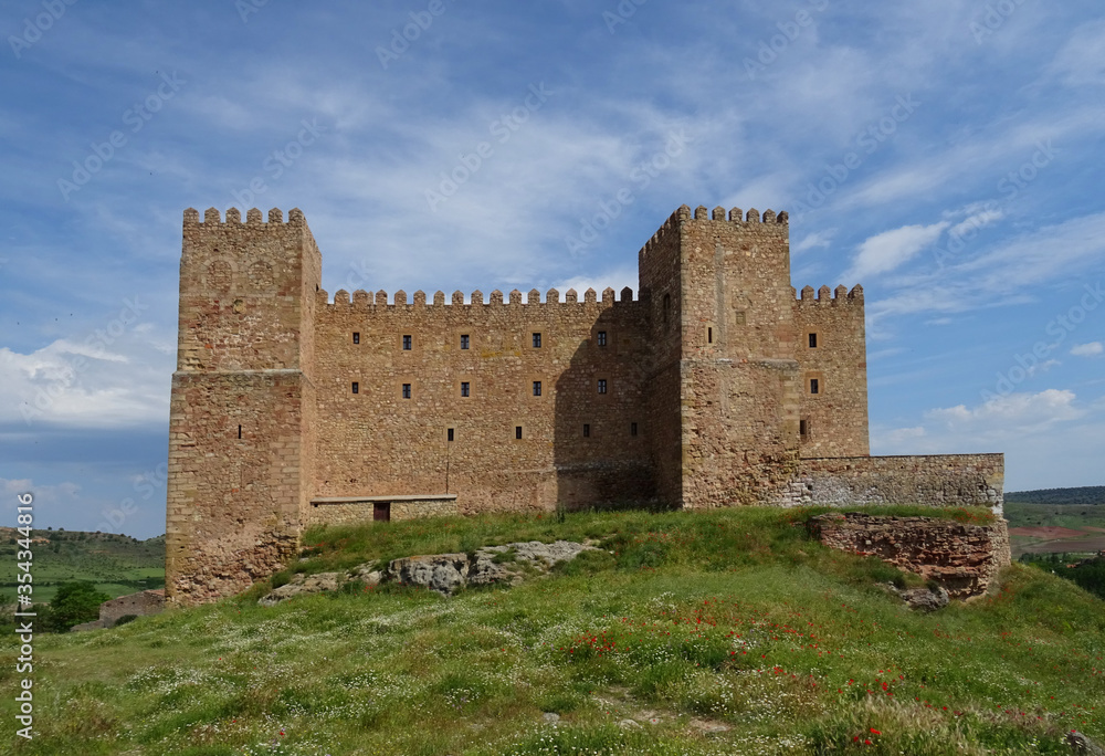 View of the Castle of Sigüenza and green meadows during spring. Guadalajara. Spain.
