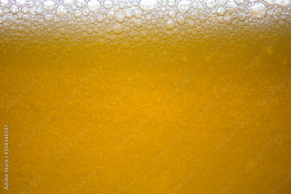 Background of close-up soda bubbles mixed with yellow fruit juice on white background. Background of close-up soda bubbles mixed with yellow fruit juice on white background.