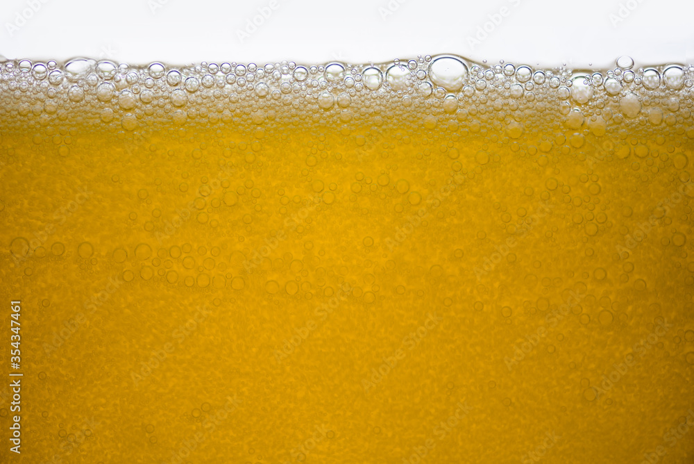 Background of close-up soda bubbles mixed with yellow fruit juice on white background. Background of close-up soda bubbles mixed with yellow fruit juice on white background.