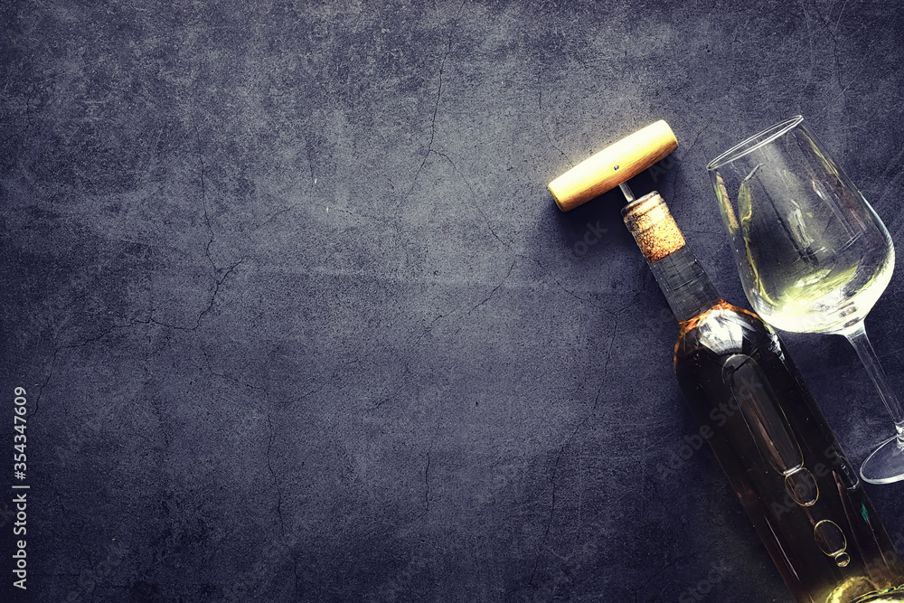 A glass of red dry wine on the table. Dark bottle and glass of wine. A glass of red dry wine on the table. Dark bottle and glass of wine.
