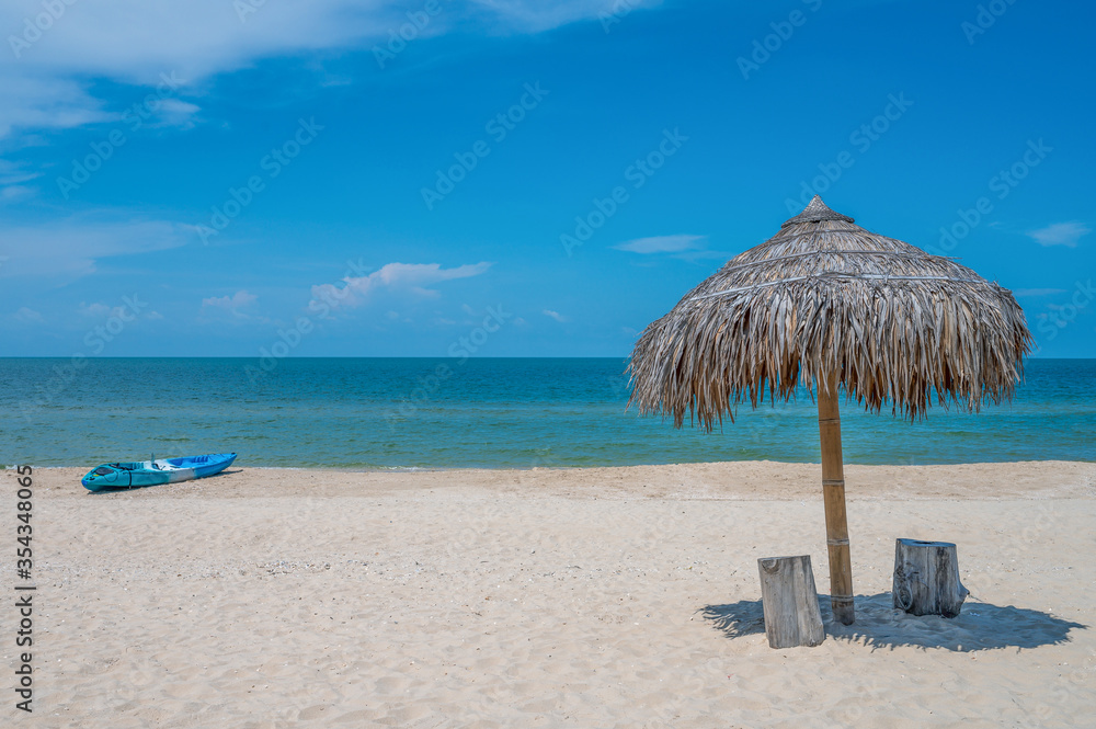 Two Chairs Under Parasol In Tropical Beach