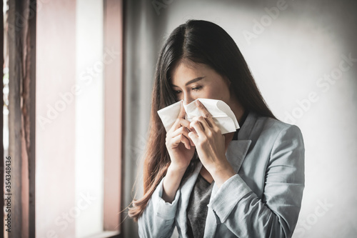 Women who have a cough and are ill with a flu infection - therefore have to use toilet paper to cover the mouth and nose.