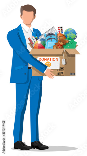 Man, cardboard donation box toys, books, clothes and devices. Help for children, support for poor kid. Donate container in hand. Social care, volunteering, charity concept. Flat vector illustration