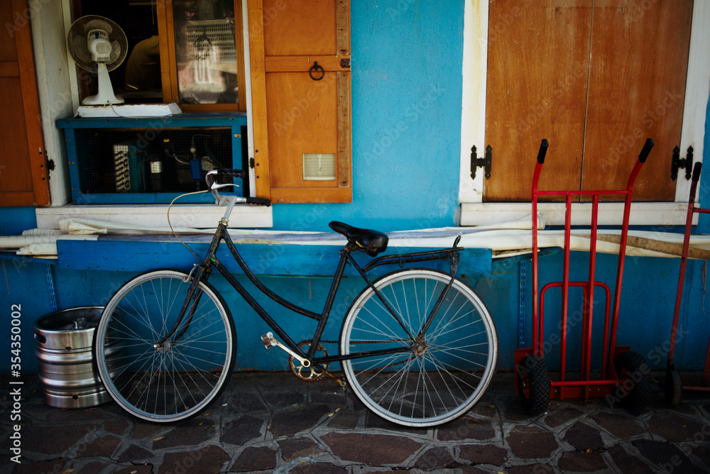 The colorful houses of Burano. Bicycle at home on the island of Murano, Venice. Italy. The colorful houses of Burano. Bicycle at home on the island of Murano, Venice. Italy.