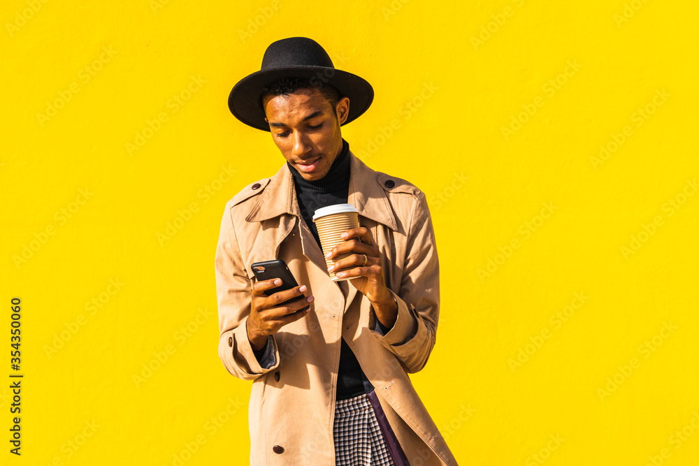 Young man with coffee cup, using smartphone Young man with coffee cup, using smartphone
