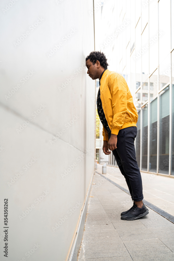Man leaning with forehead on a wall Man leaning with forehead on a wall