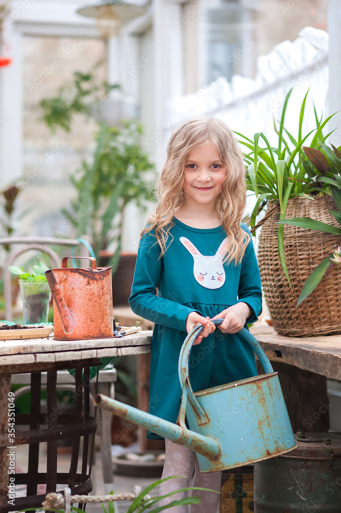 Fototapeta premium Stay at home. Home gardening in the greenhouse. Girls sisters and house plants. Urban jungle.