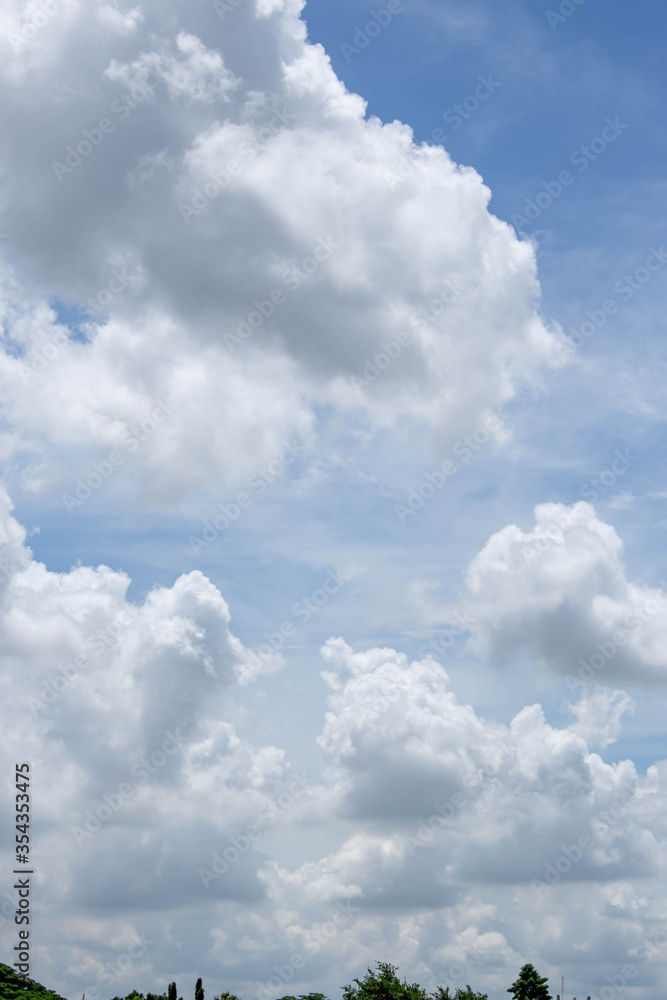 Obraz premium Bright blue sky with fluffy white clouds. Clearing day and Good weather. Blue sky background.