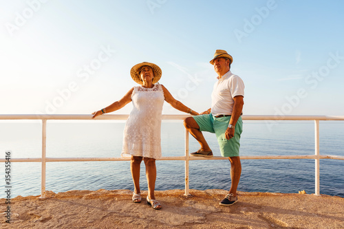 Senior couple at viewpoint at the coast, El Roc de Sant Gaieta, Spain photo