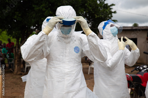 Lunsar, Sierra Leone, July 8, 2015: Buerial team members ready to take a body in a village. ebola response epidemic disease in Africa, ebola and corona virus context. Editorial use photo
