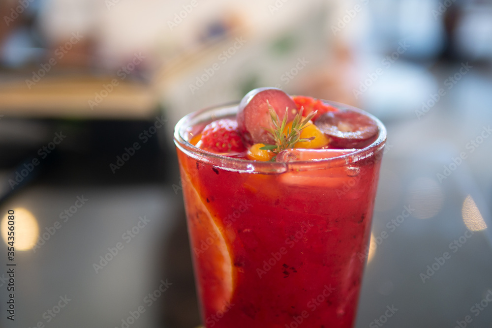 Herbal cold brew tropical fruit berries tea mocktail or cocktail drink beverage in cafe for healthy lifestyle and summer refreshment Herbal cold brew tropical fruit berries tea mocktail or cocktail drink beverage in cafe for healthy lifestyle and summer refreshment