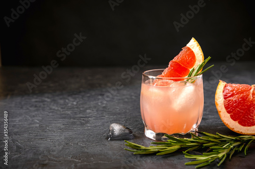 Pink Grapefruit Cocktail Spritze With Rosemary And Melting Ice