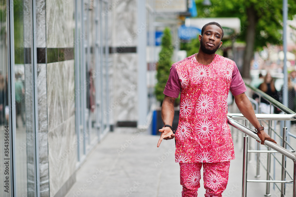 Portrait of a black young man wearing african traditional red colorful clothes. Portrait of a black young man wearing african traditional red colorful clothes.