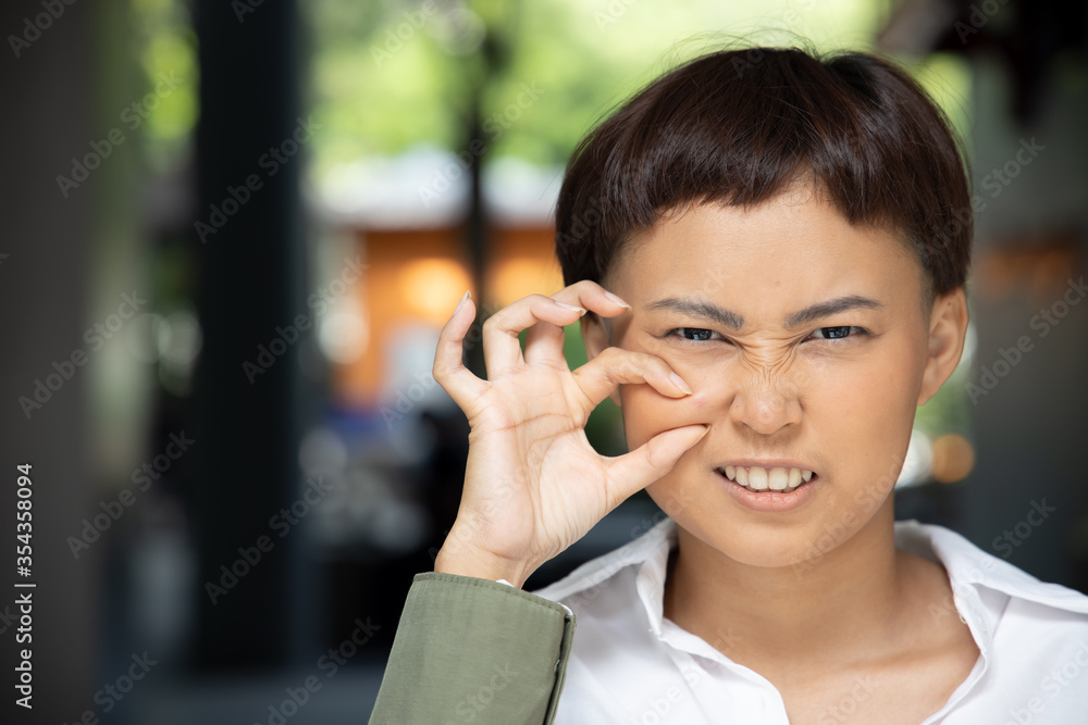 unhappy woman squeezing acne on her cheek face; concept of facial skin care, acne treatment, pimple, zit inflammation unhappy woman squeezing acne on her cheek face; concept of facial skin care, acne treatment, pimple, zit inflammation
