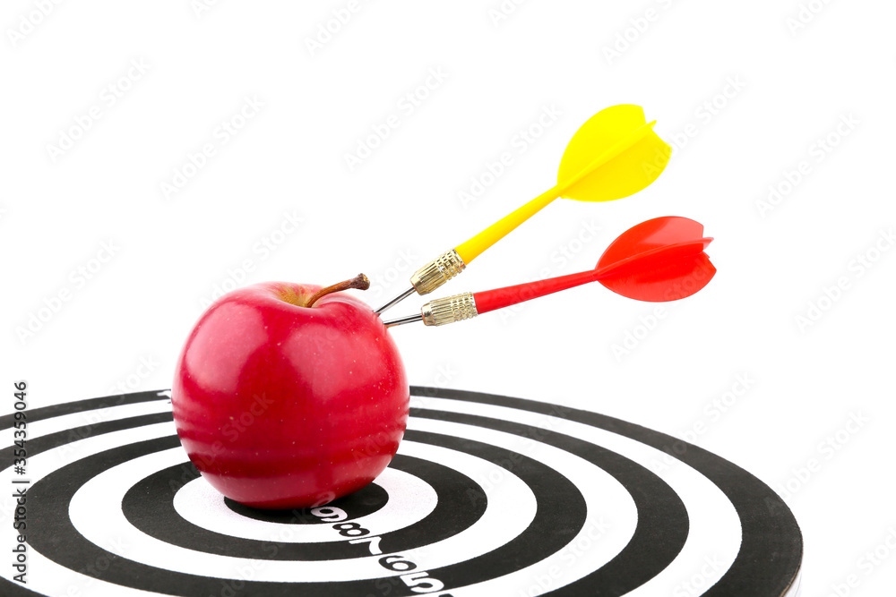 concept of successful team work. two darts sticks out of an apple on a dart board. dart hit an apple on a white background concept of successful team work. two darts sticks out of an apple on a dart board. dart hit an apple on a white background