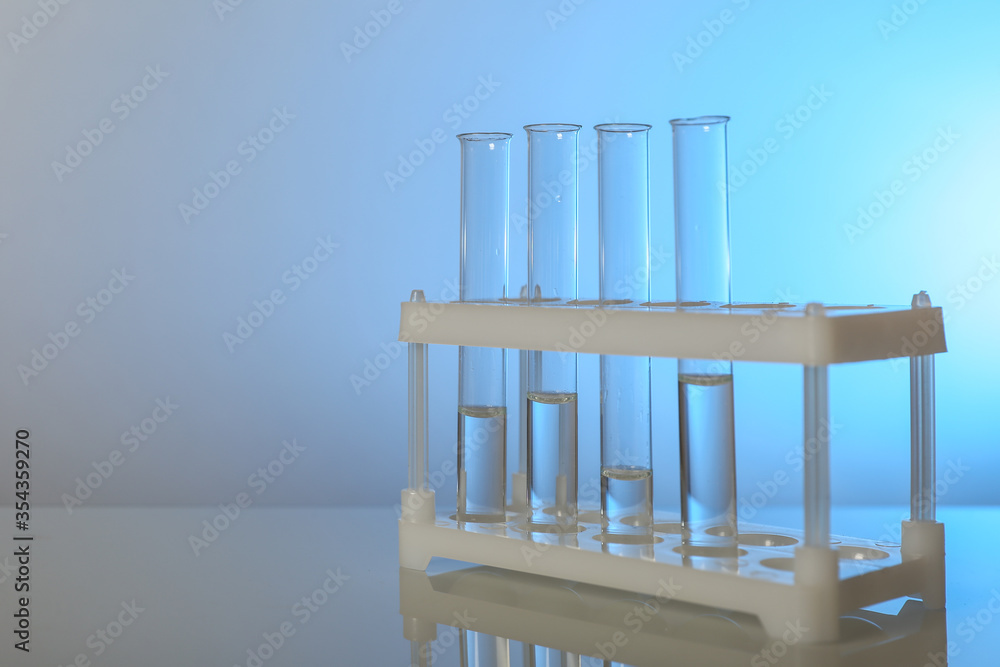 conceptual background with chemical flasks. blue backdrop with lab glassware with copy space. conceptual background of chemistry science in laboratory conceptual background with chemical flasks. blue backdrop with lab glassware with copy space. conceptual background of chemistry science in laboratory