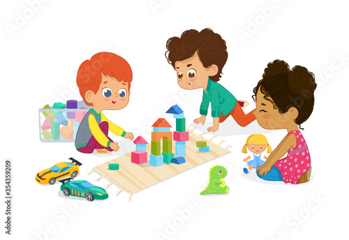 Children sit in circle and play with toys in the kindergarten classroom, play with wooden toy blocks, cars, doll and laugh. Learning through entertainment concept.