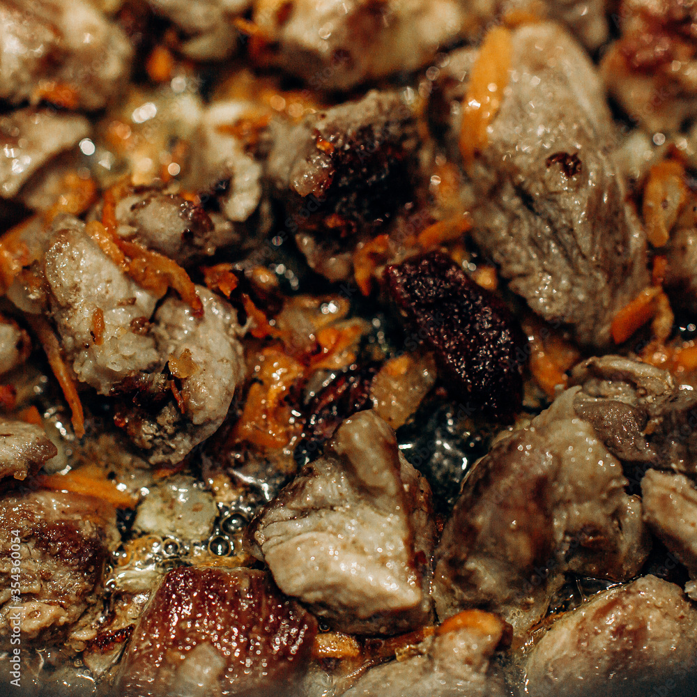 Onions with carrots are fried. Home cooking. Pilaf with meat Onions with carrots are fried. Home cooking. Pilaf with meat