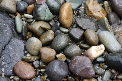 Pebble beach. Wet pebbles closeup.