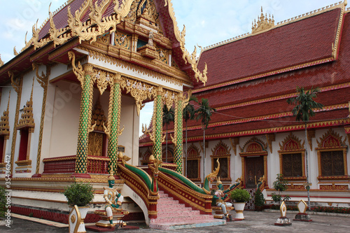 Panoramic view of intensively decorated and painted temple main hall buildings Siamese Lao PDR, Southeast Asia