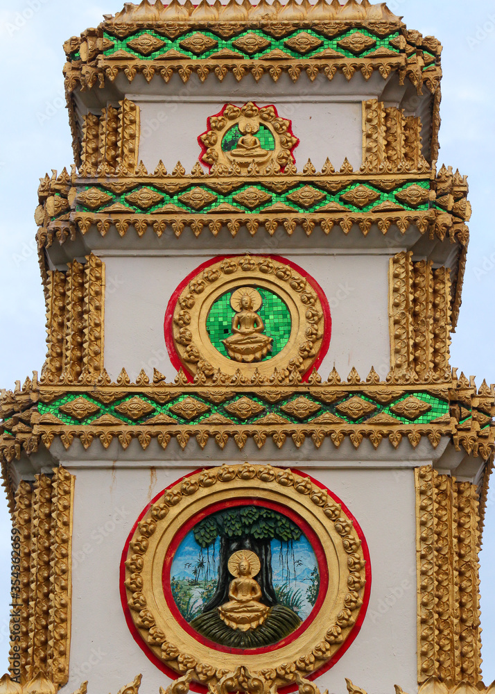 Obraz premium Top or tower on top of a entrance gate showing 3 different buddha images and frescos in a temple in Siamese Lao PDR, Southeast Asia