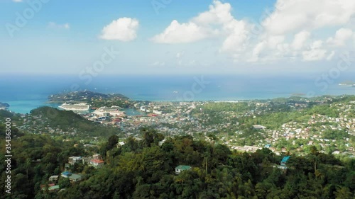 Wallpaper Mural Aerial shot of the horizon where the sky merges with the sea. On the shore of the mountain, a dense forest and a city with vessels.(Rodney Bay, Saint Lucia) Torontodigital.ca