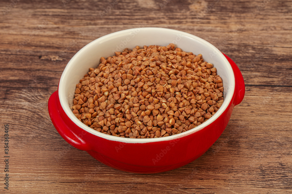 Raw buсkwheat cereal in the bowl Raw buсkwheat cereal in the bowl