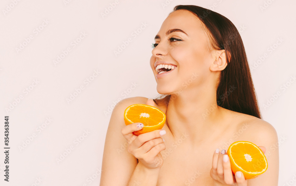 Happy beautiful girl have fun with slices of orange fruit in hands and smile isolated on white background. Young cheerful woman beauty model posing with citrus fruit. Cosmetology, peeling, skin care Happy beautiful girl have fun with slices of orange fruit in hands and smile isolated on white background. Young cheerful woman beauty model posing with citrus fruit. Cosmetology, peeling, skin care